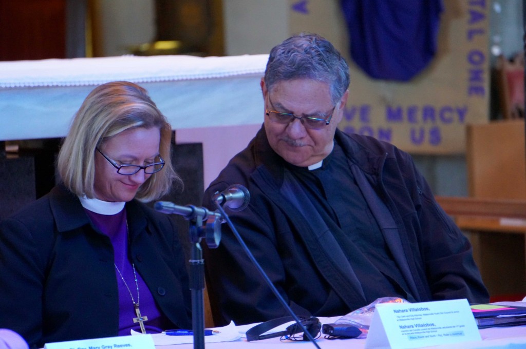 Bishop Mary and Bishop Richard look up the words for the Prayer of St. Francis.