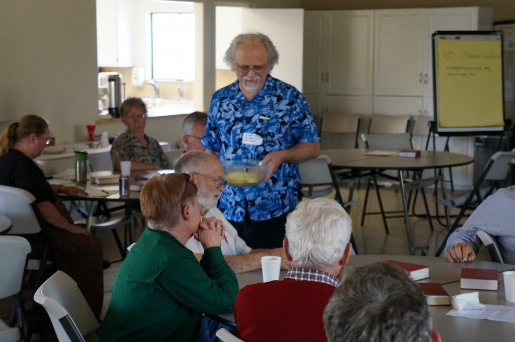 The Rev. Blaine Hammond invites deanery delegates to choose congregational prayer partners out of a bowl.